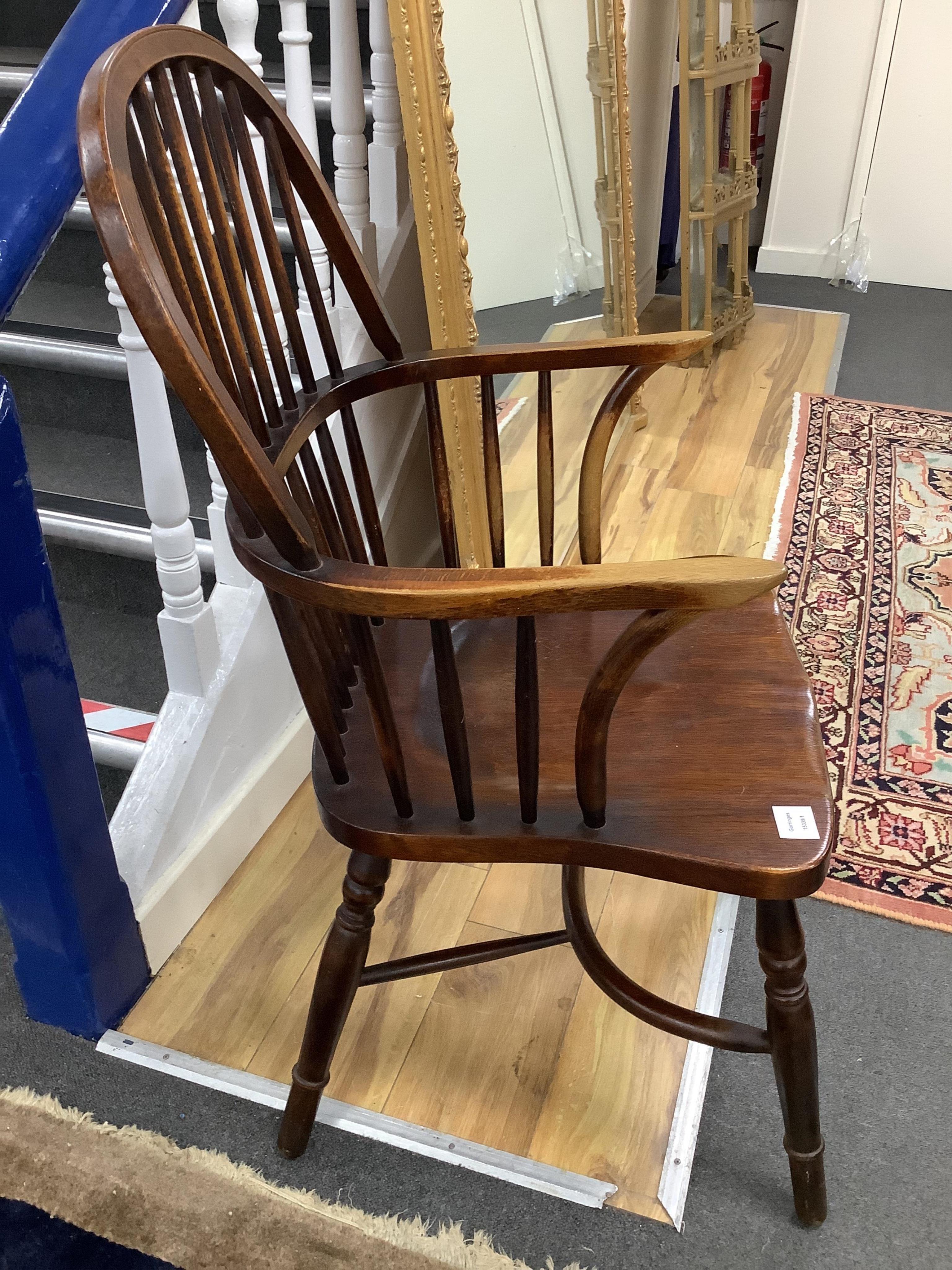 An early 20th century Windsor comb back armchair, width 53cm, depth 48cm, height 101cm. Condition - fair